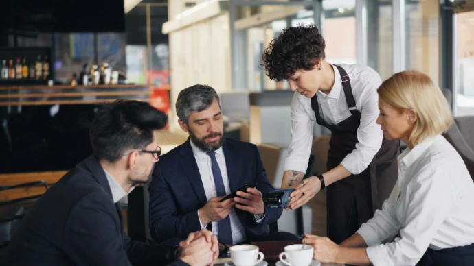 a group of people sitting around a table